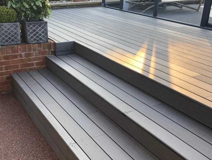 High quality decking with steps leading down to gravel.